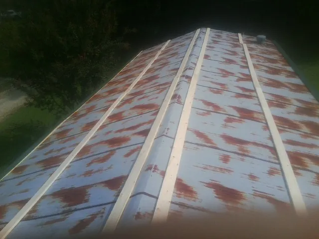 Rusted metal roof panels with new wood purlins before replacement — Storm Damage Roof Repair in Huguenot by Roofing Brothers
