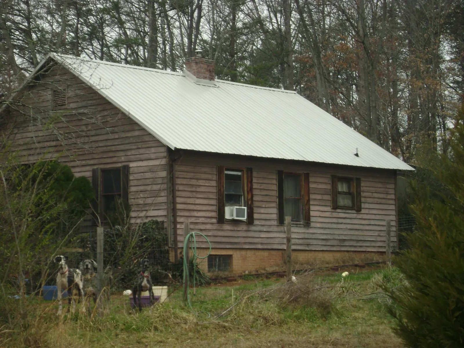 White metal roof on an old wood sided farmhouse, from a Metal Roof Installation job in Huguenot